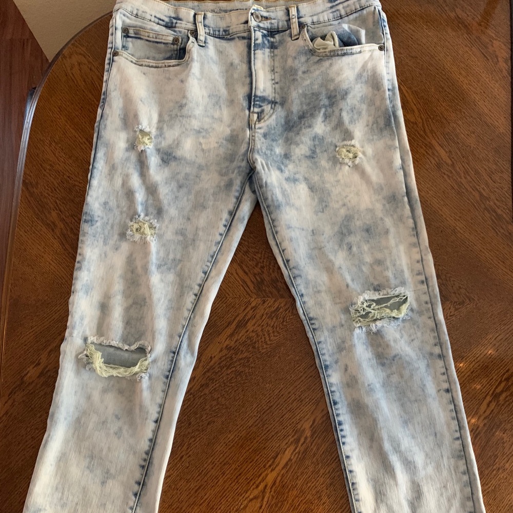 Nice pair of blue faded ripped jeans.